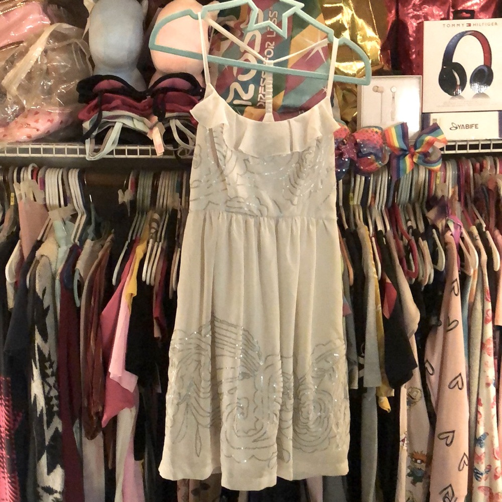 White dress. Side invisible zipper on side. Silver sequin design. Worn 1 time.